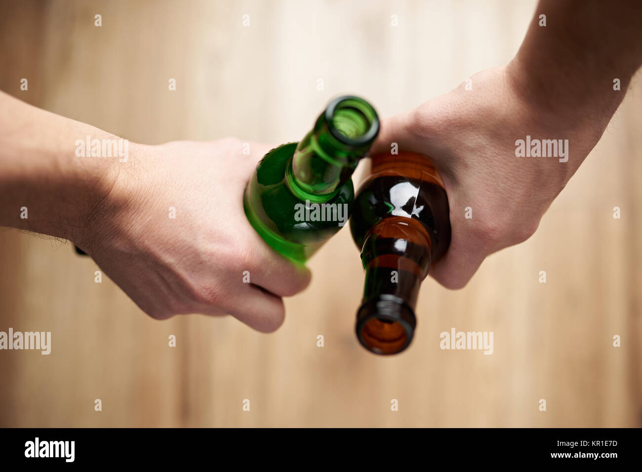 Friends hold beer bottles closeup above top view Stock Photo Alamy