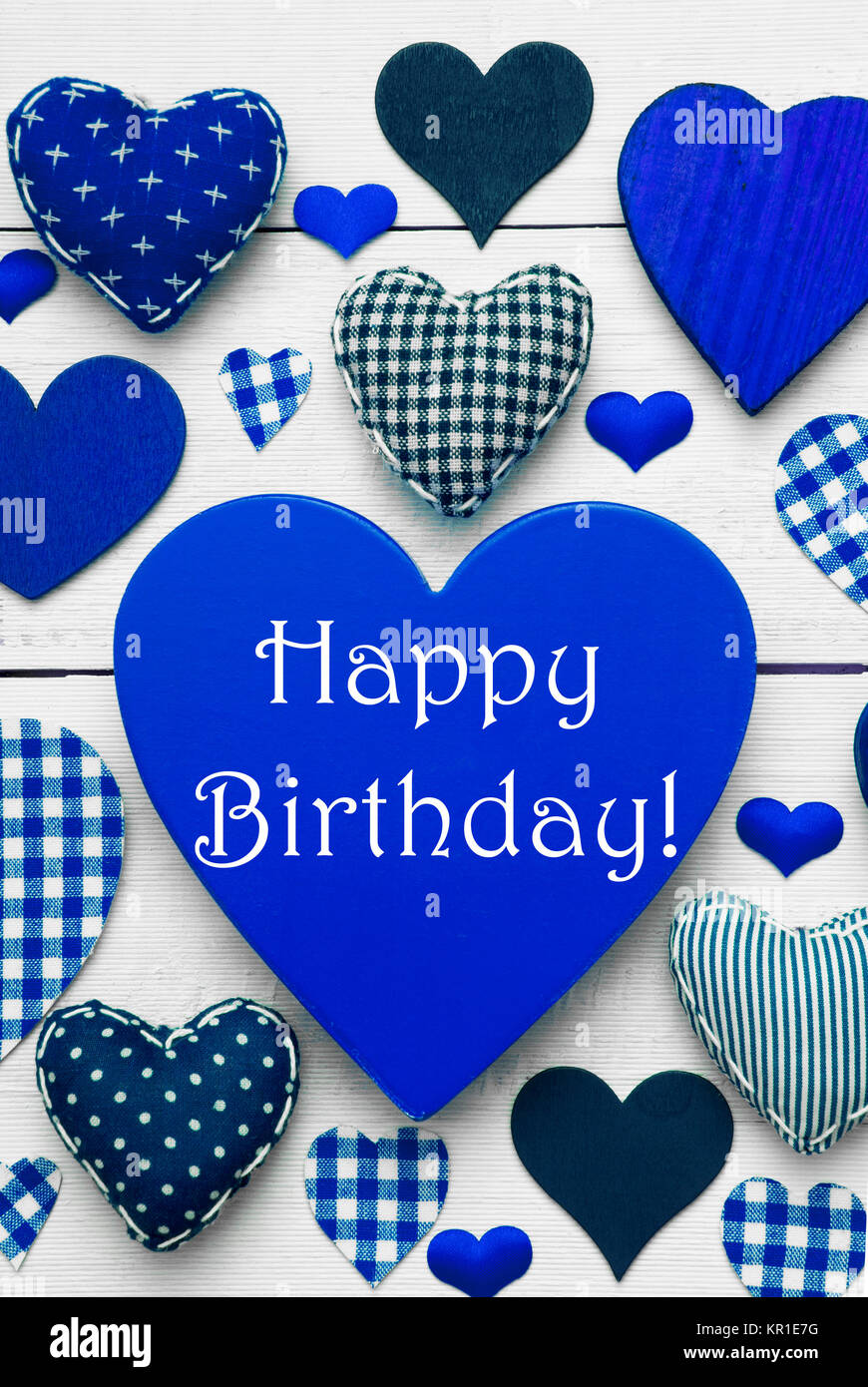 Blue Vertical Heart Texture With English Text Happy Birthday. White Wooden  Background. Textile Hearts Which Are Dotted and Striped. Greeting Card With  Congratulations Stock Photo - Alamy