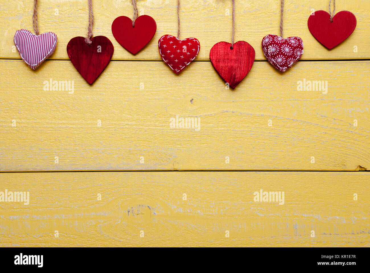 Wooden Background With Red And Yellow Hearts Hanging In A Row. Copy ...