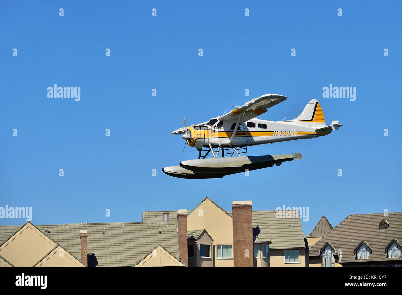 A commuter float plane coming in for a landing on the waters of Victoria harbour on Vancouver Island British Columbia Canada. Stock Photo
