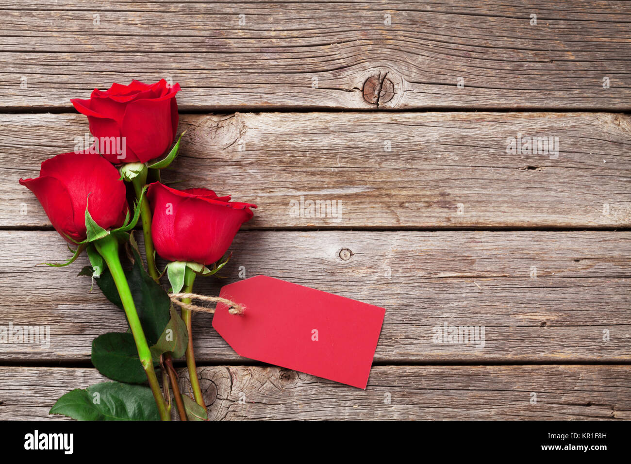 Valentines day greeting card. Red roses on wooden table. Top view with ...