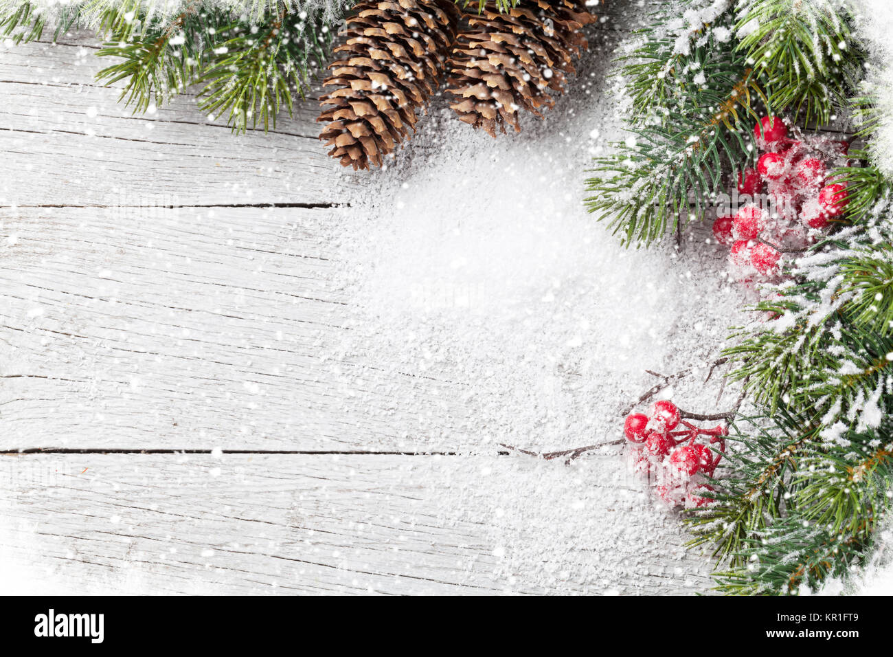 Christmas background with snow fir tree on wooden table. Top view with ...