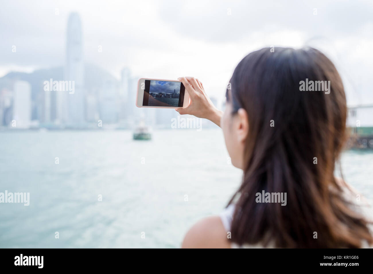 Woman taking photo of Hong Kong Stock Photo - Alamy