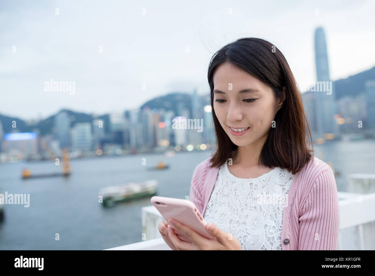 Woman use of mobile phone at Hong Kong Stock Photo - Alamy