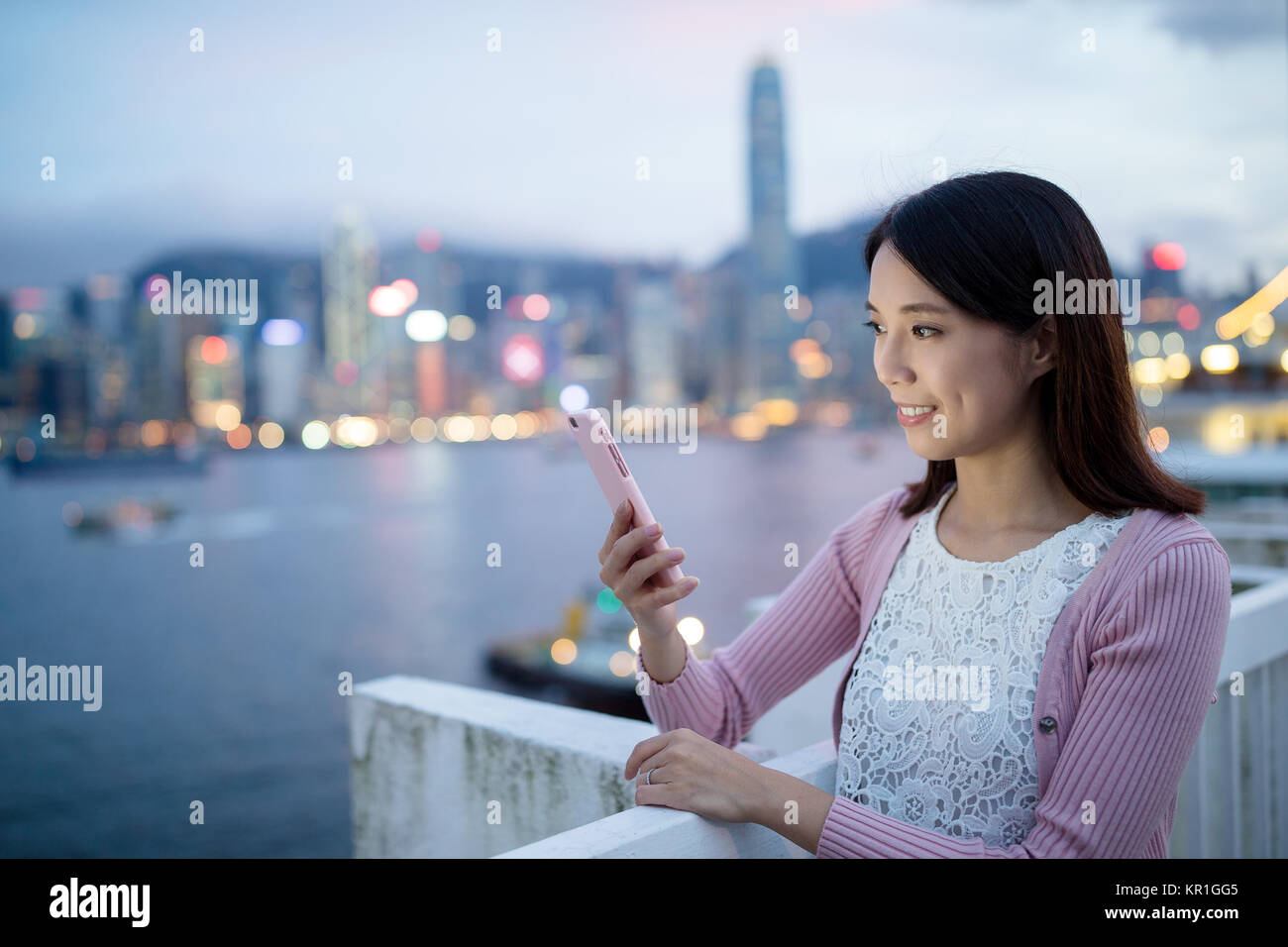 Woman hold with cellphone in Hong Kong at night Stock Photo - Alamy
