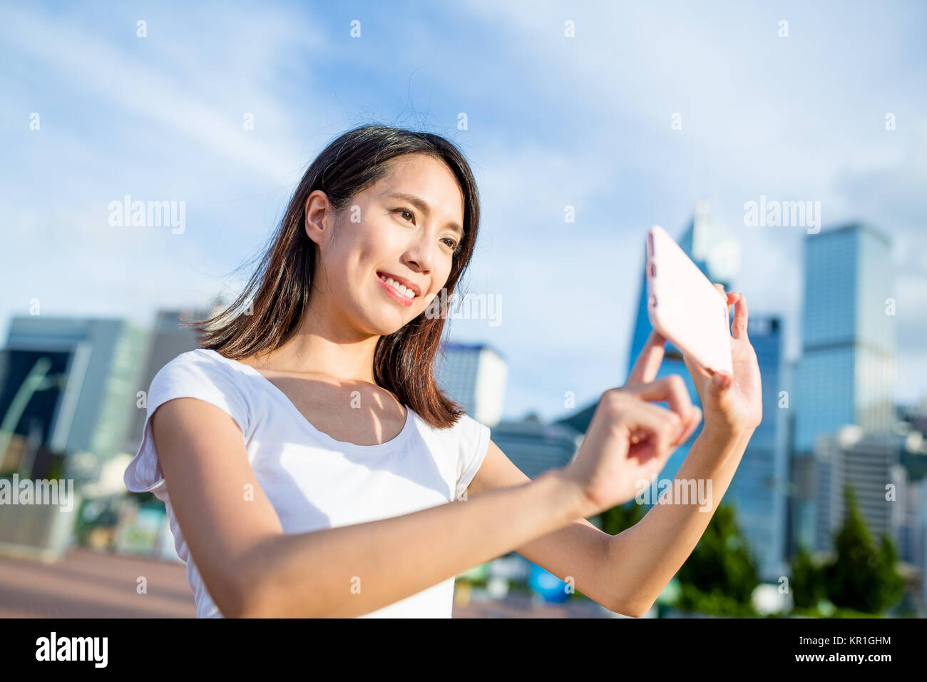 Woman taking phone in Hong Kong city Stock Photo - Alamy