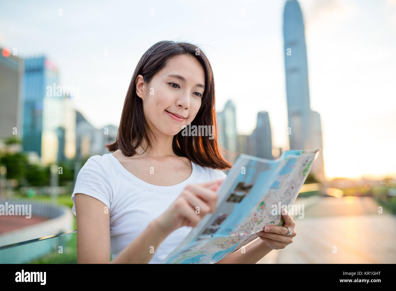 Woman looking at city map in Hong Kong Stock Photo - Alamy