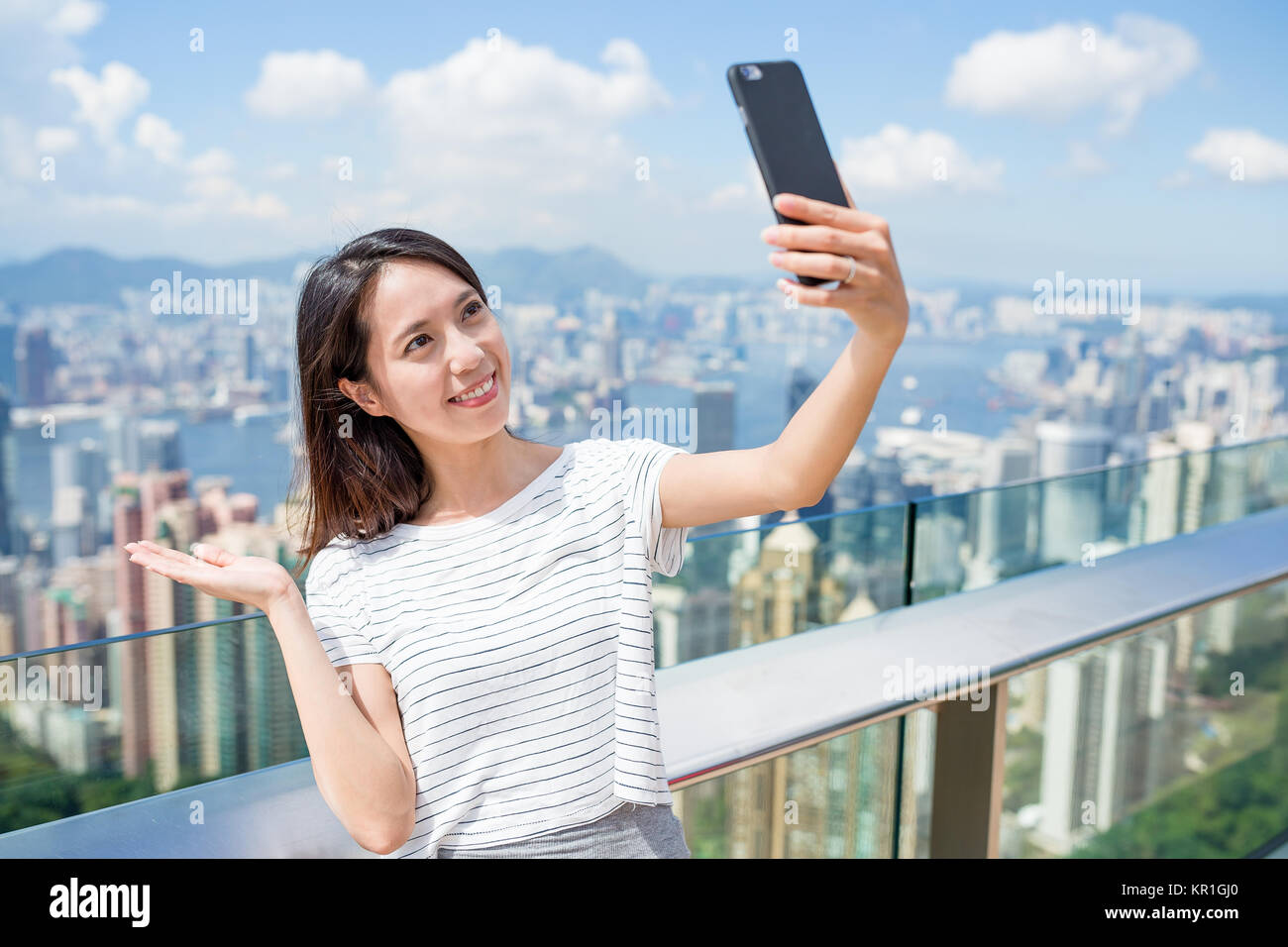 Woman taking selfie by mobile phone in The Peak of Hong Kong Stock ...
