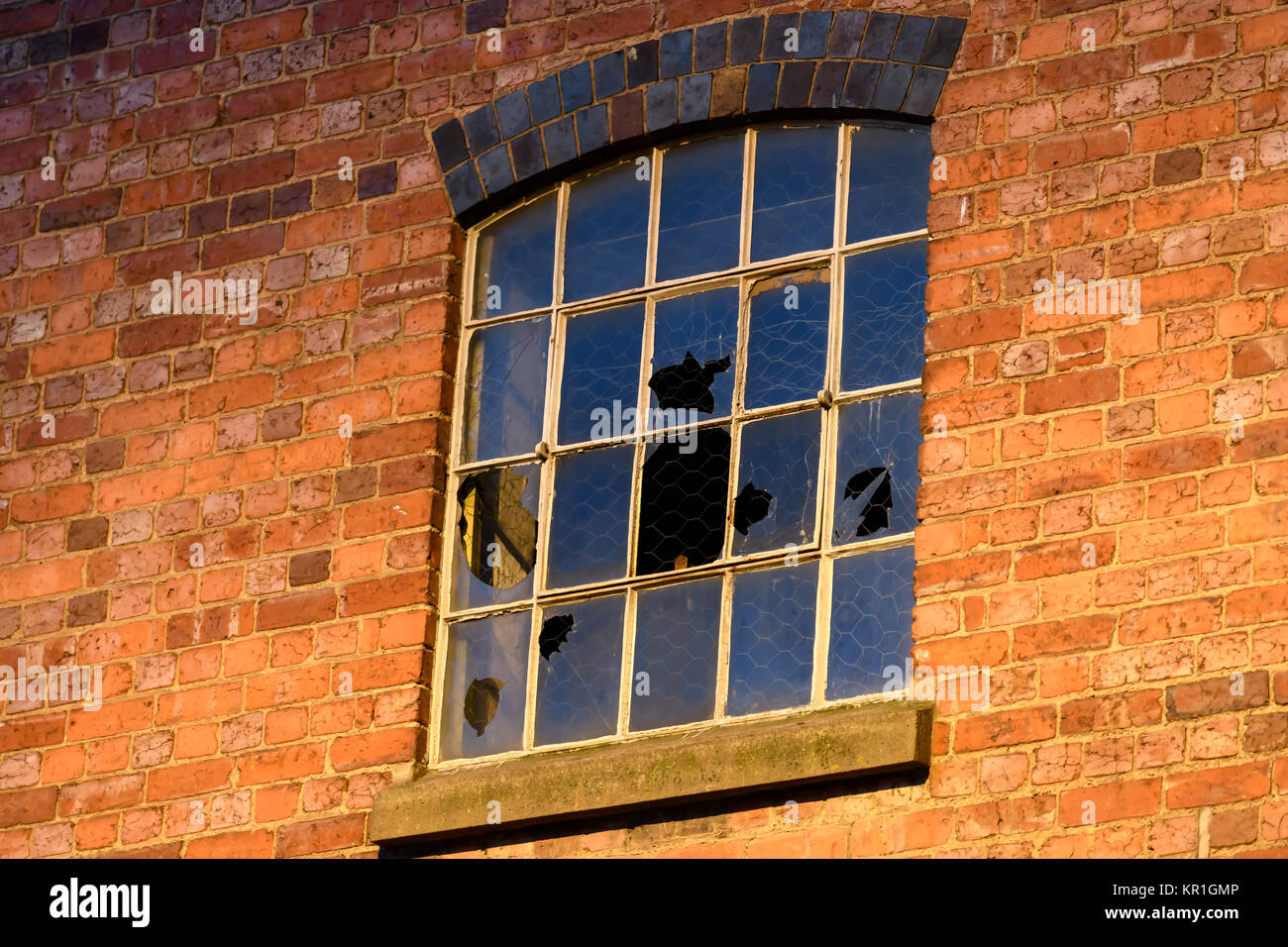 Broken windows in an abandoned building Stock Photo - Alamy
