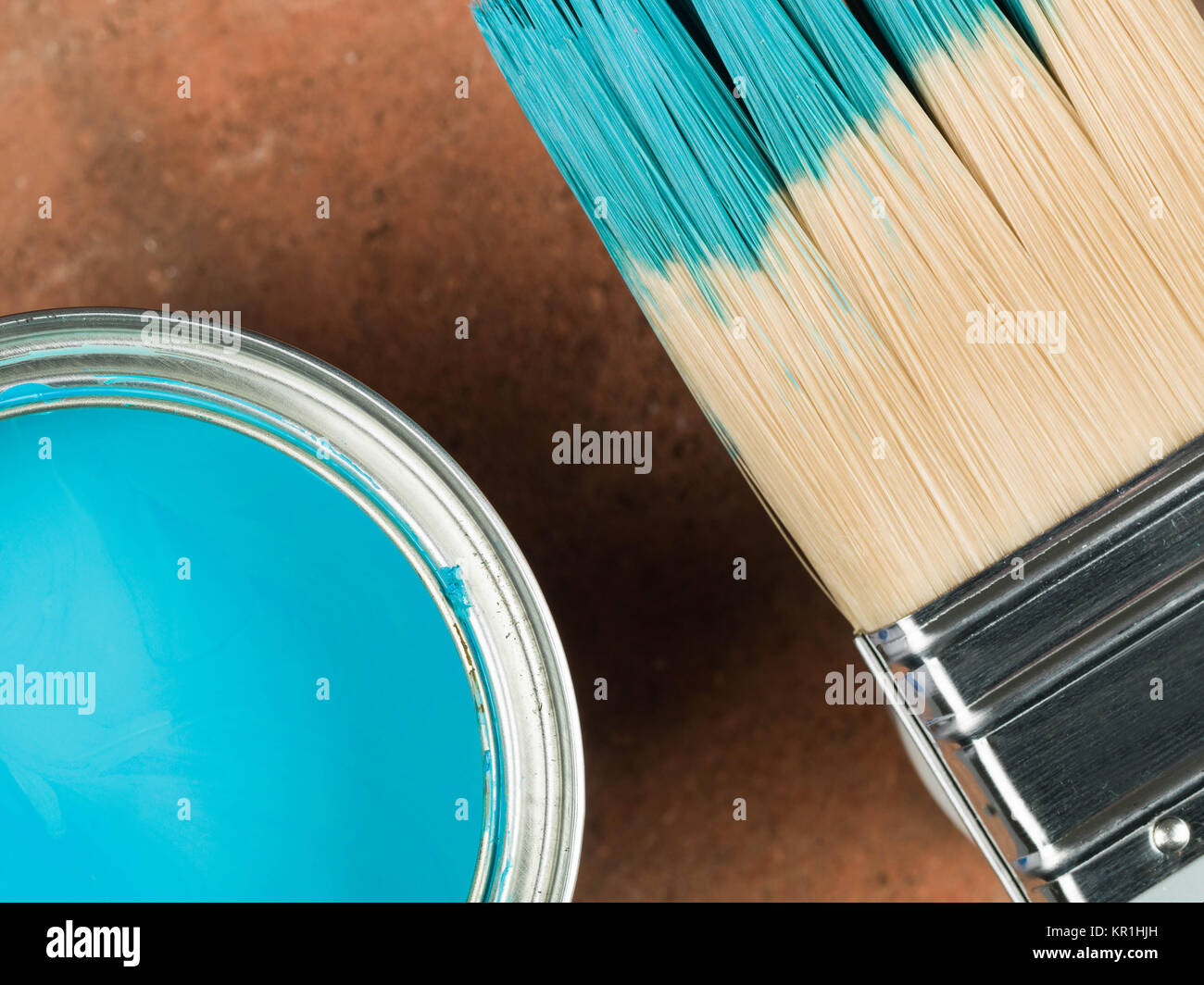 Open Tin of Blue Household Decorating Gloss Paint With a Paint Brush Stock Photo