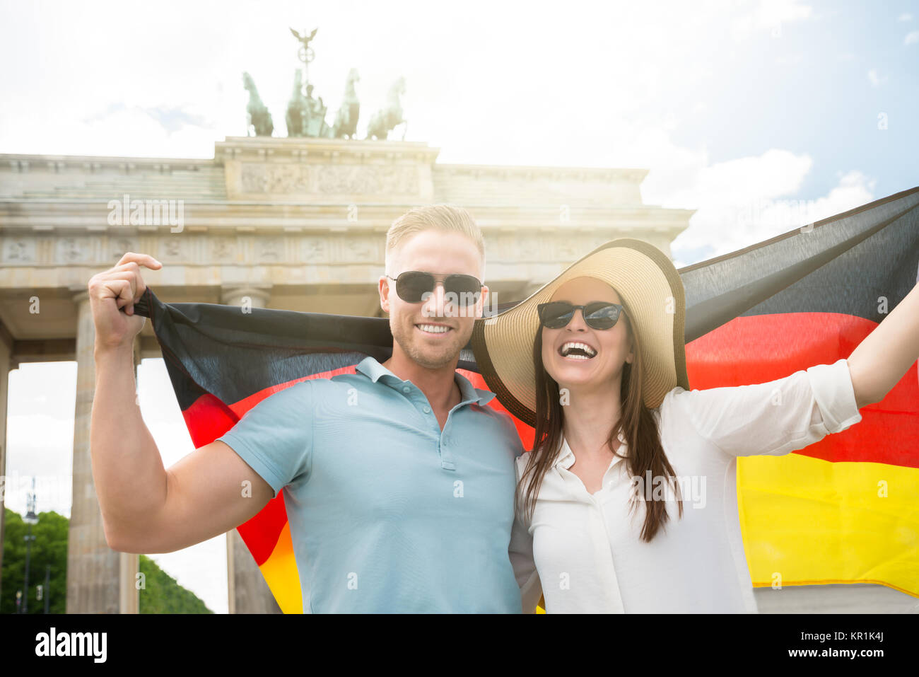 Smiling Couple Holding German Flag Stock Photo