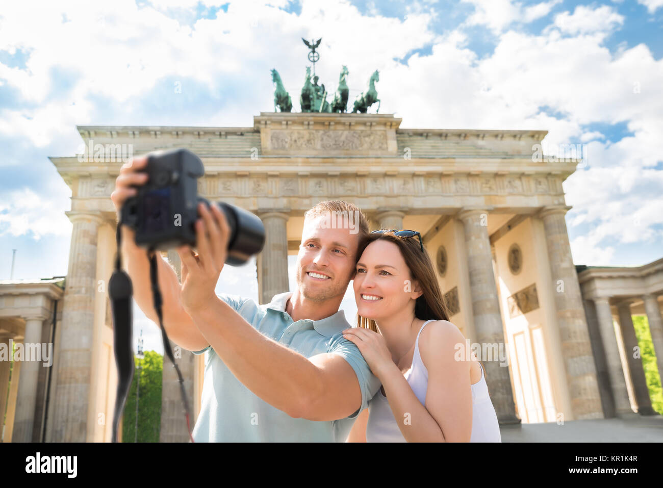 Young Couple Taking Selfie In Front Of Brandenburg Gate Stock Photo