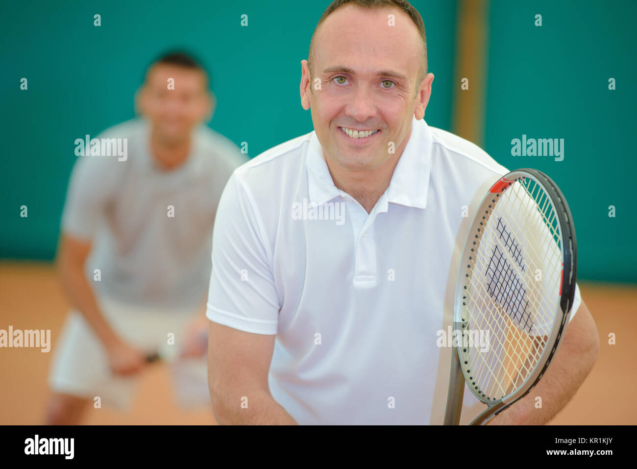 Two smiling men playing tennis Stock Photo