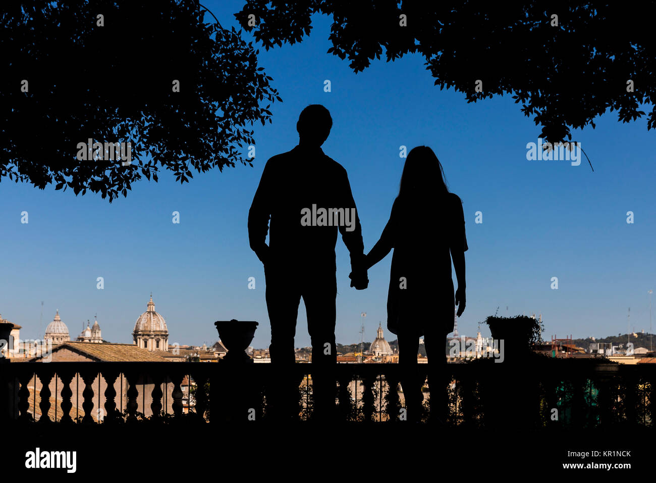 Silhouette couple holding hands overlooking the city of Rome Italy Stock Photo