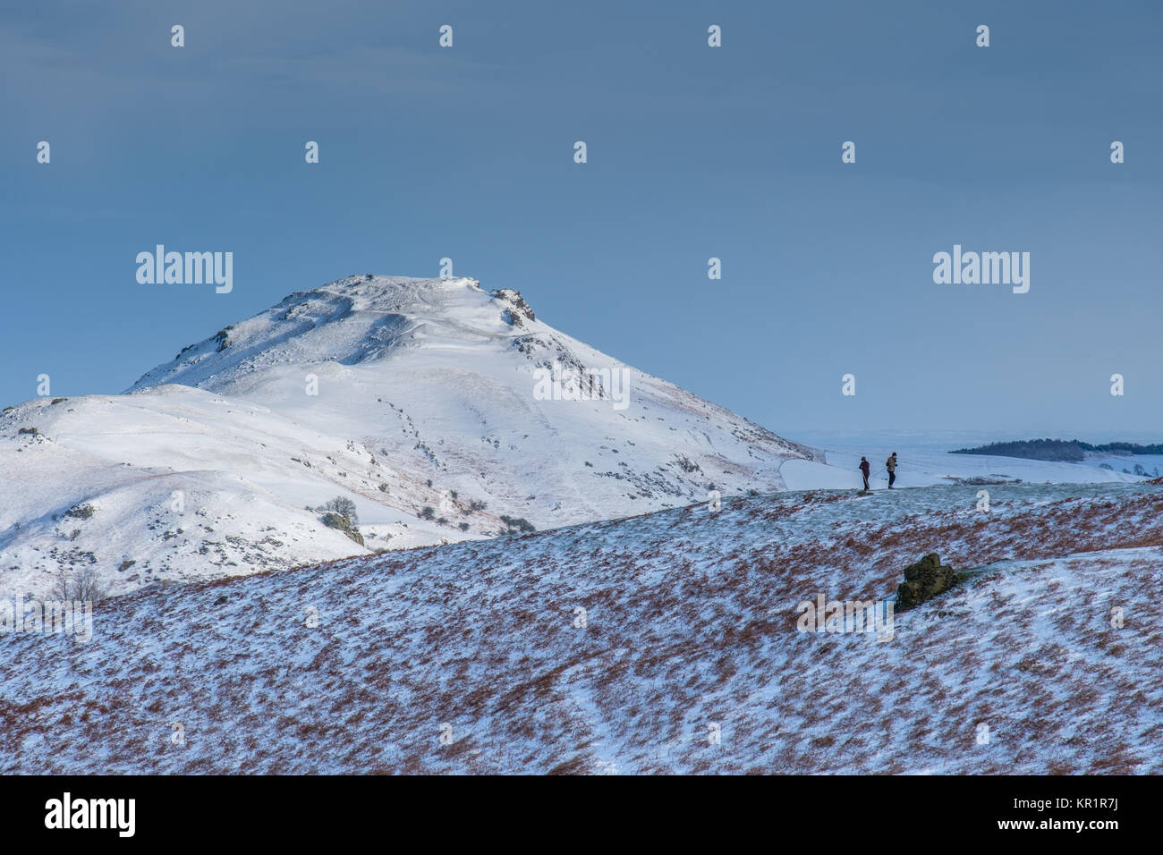 Two walkers looking at Caer Caradoc from Ragleth Hill, near Church Stretton, Shropshire, UK Stock Photo