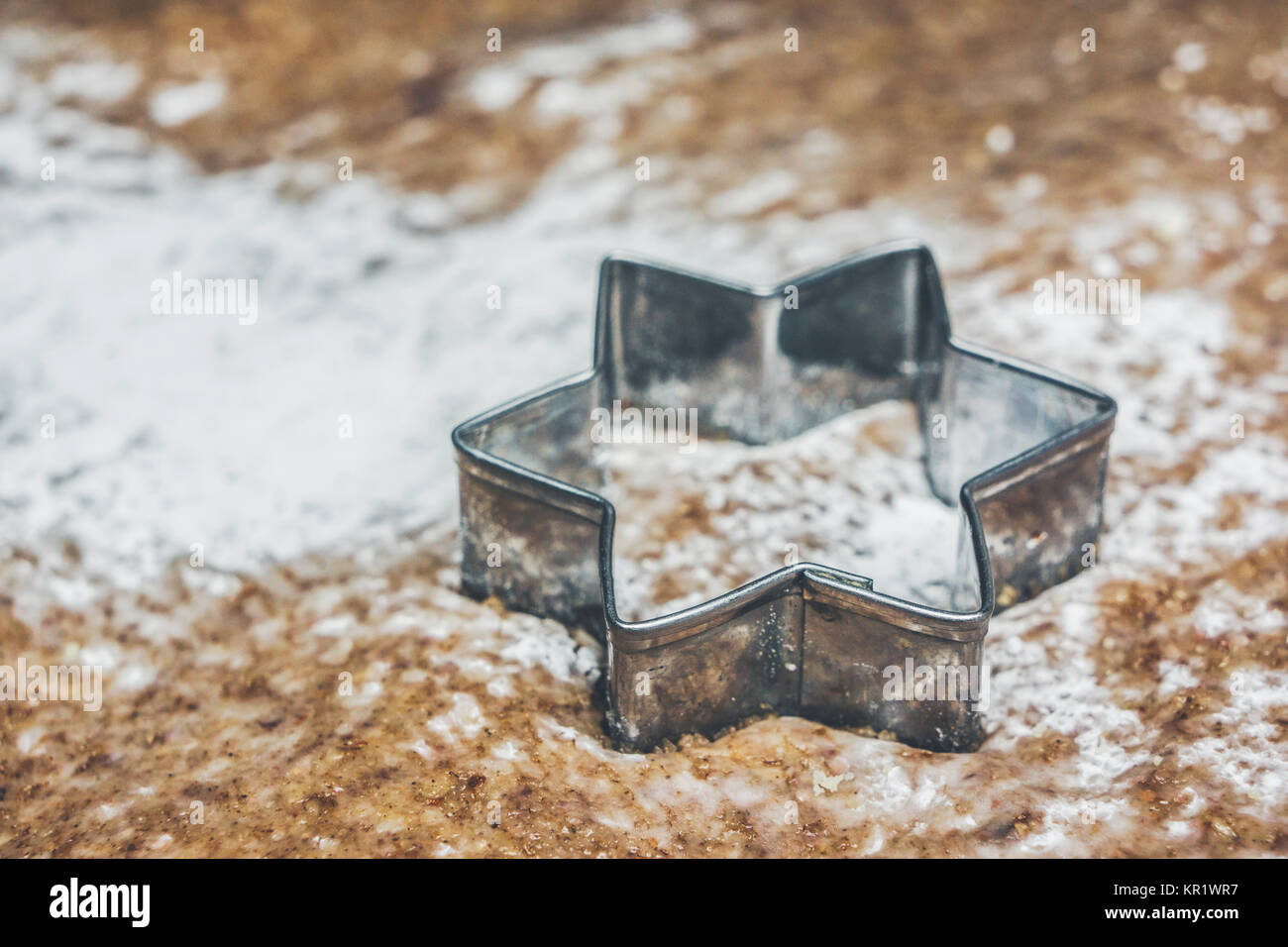 A star shaped pastry cutter on a pastry ready to make traditional christmas cookies. Stock Photo