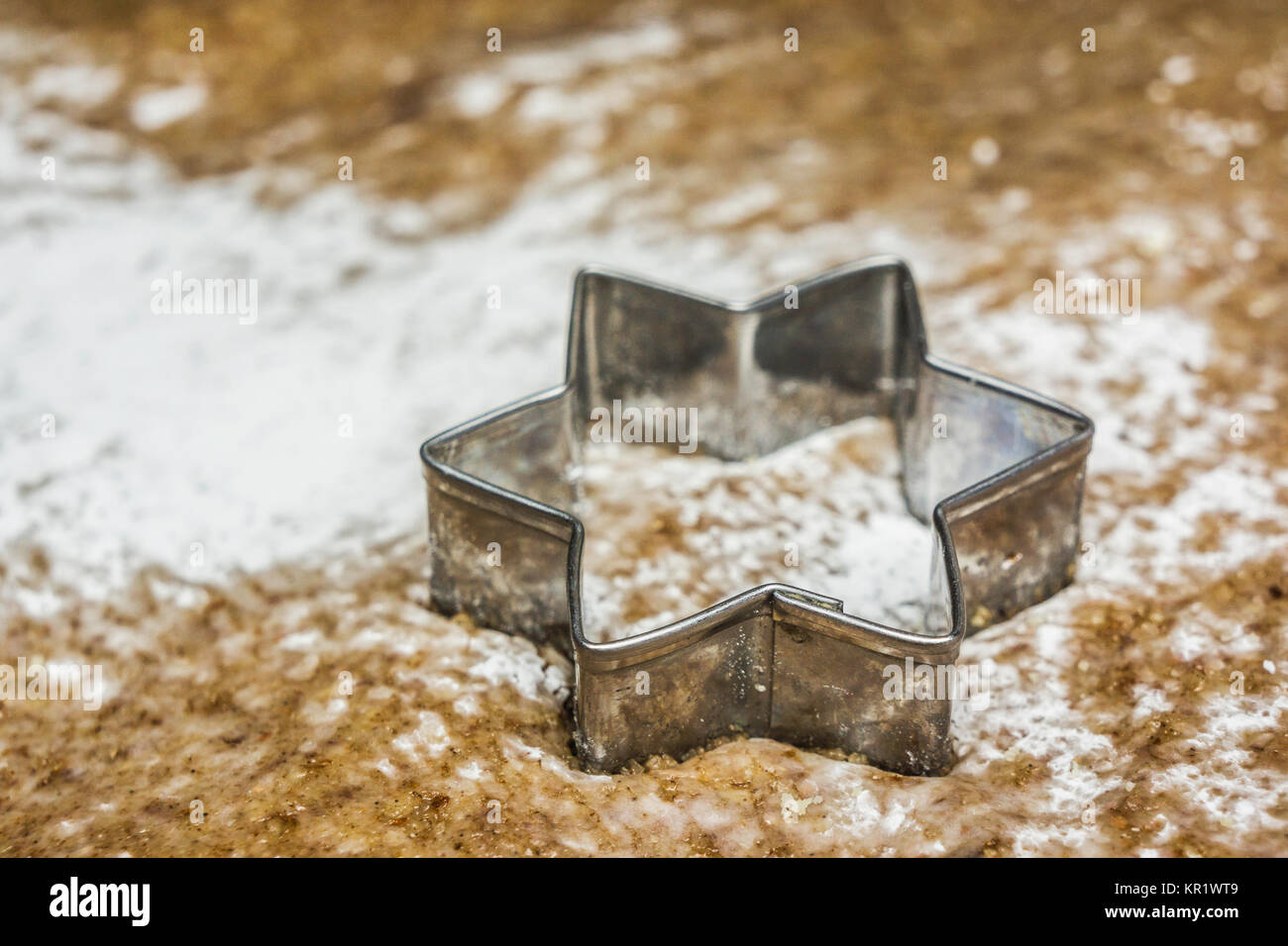 A star shaped pastry cutter on a pastry ready to make traditional christmas cookies. Stock Photo