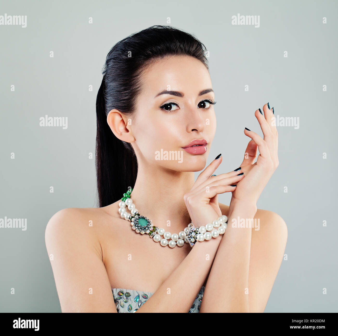 Beautiful Woman with Makeup and Pearls Jewelry Stock Photo