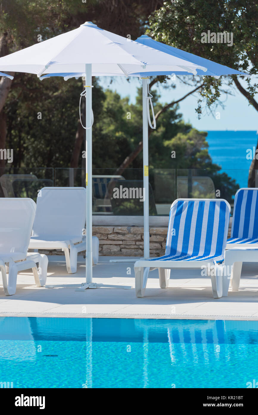 sunbeds and umbrellas by the swimming pool on a sunny day Stock Photo ...