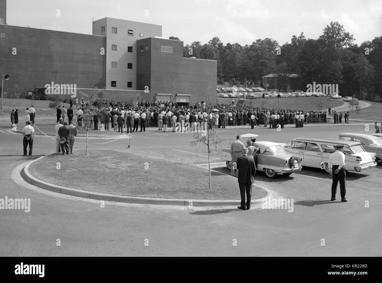 A 1960 CDC Dedication Ceremony looking at the rear of Bldg, 1960. 3. CDC dedication crowd shown from behind. The ceremony marked the new location of the CDC on Clifton Road in Atlanta, Georgia. Image courtesy CDC. Stock Photo