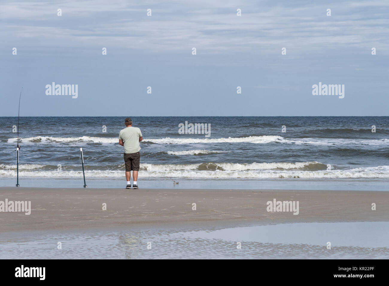 Man Fishing on a Florida Ocean Beach Shoreline United States Stock Photo