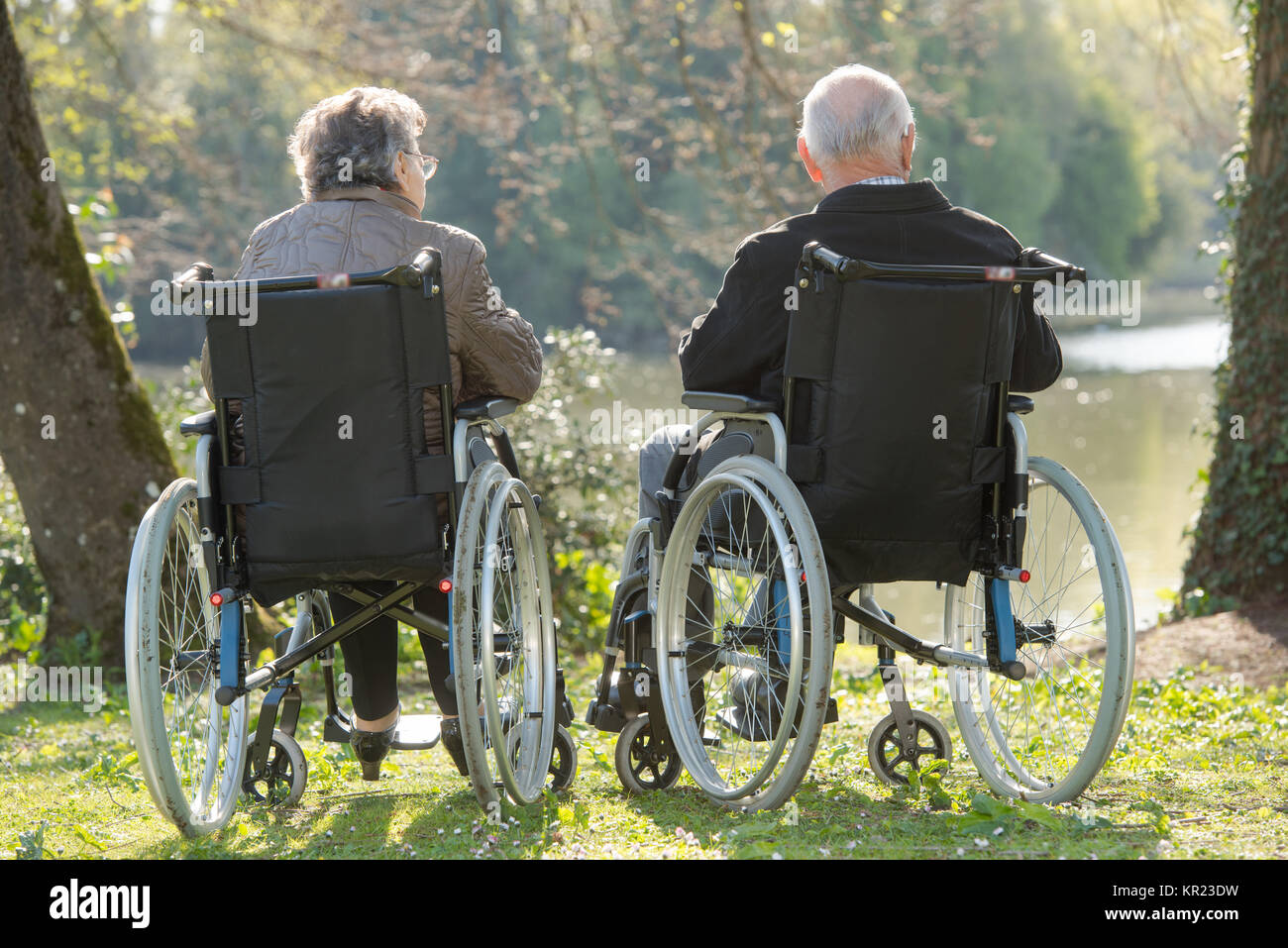 Elderly couple in wheelchairs, looking at view Stock Photo Alamy