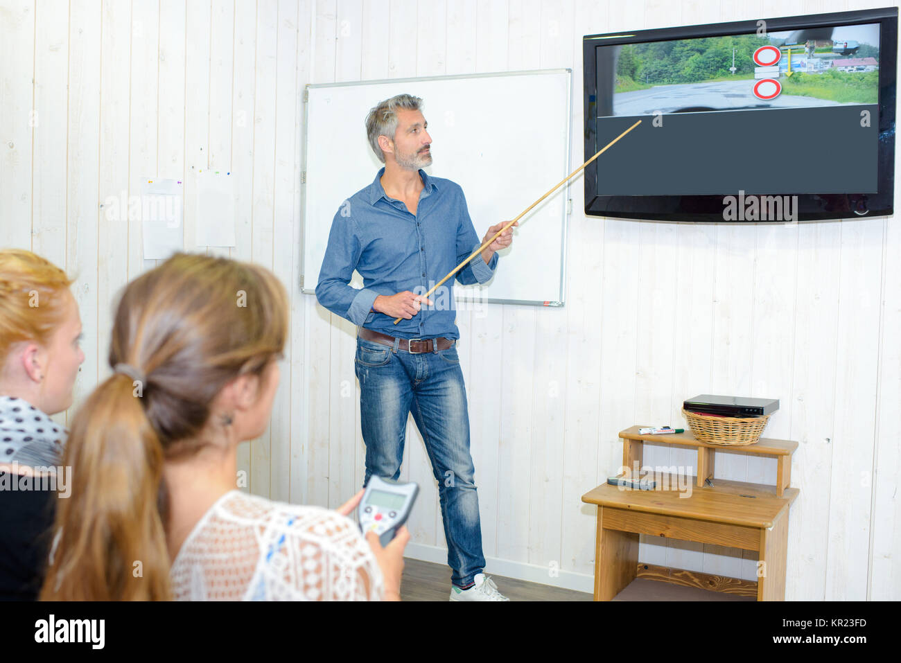 Driving instructor teaching highway code Stock Photo - Alamy
