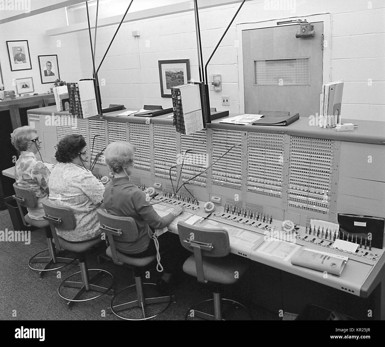 This historic image depicts a number of operators answering calls at what was the Centers for Disease Control and Prevention's (CDC) switchboard. Image courtesy CDC, 1975. Stock Photo