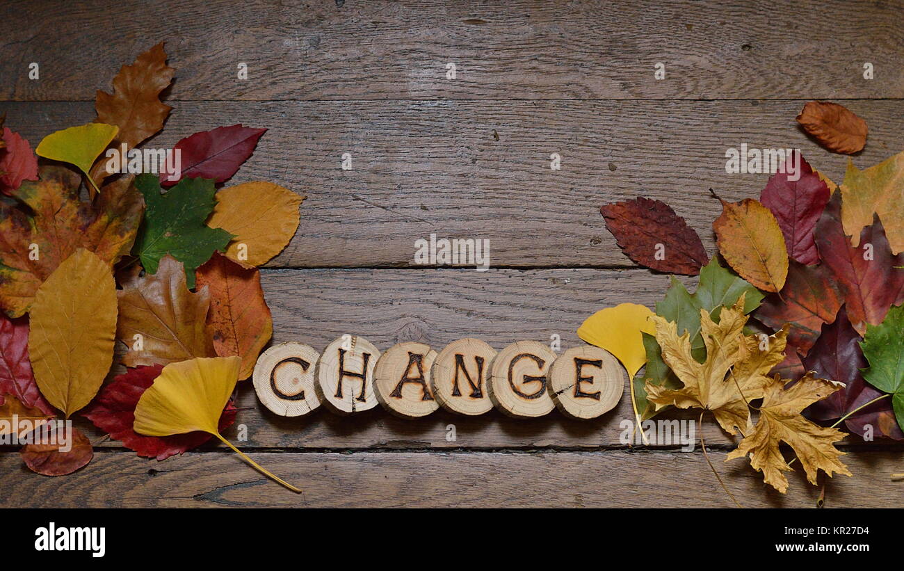 changing colorful leaves on wooden planks with the word CHANGE Stock Photo