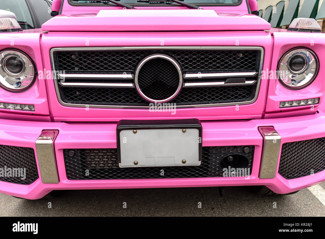 modern, new, expensive, pink SUV car, stands in summer in the city in ...