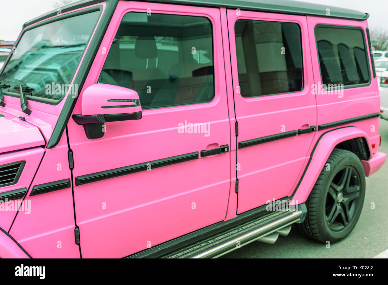 modern, new, expensive, pink SUV car, stands in summer in the city in ...