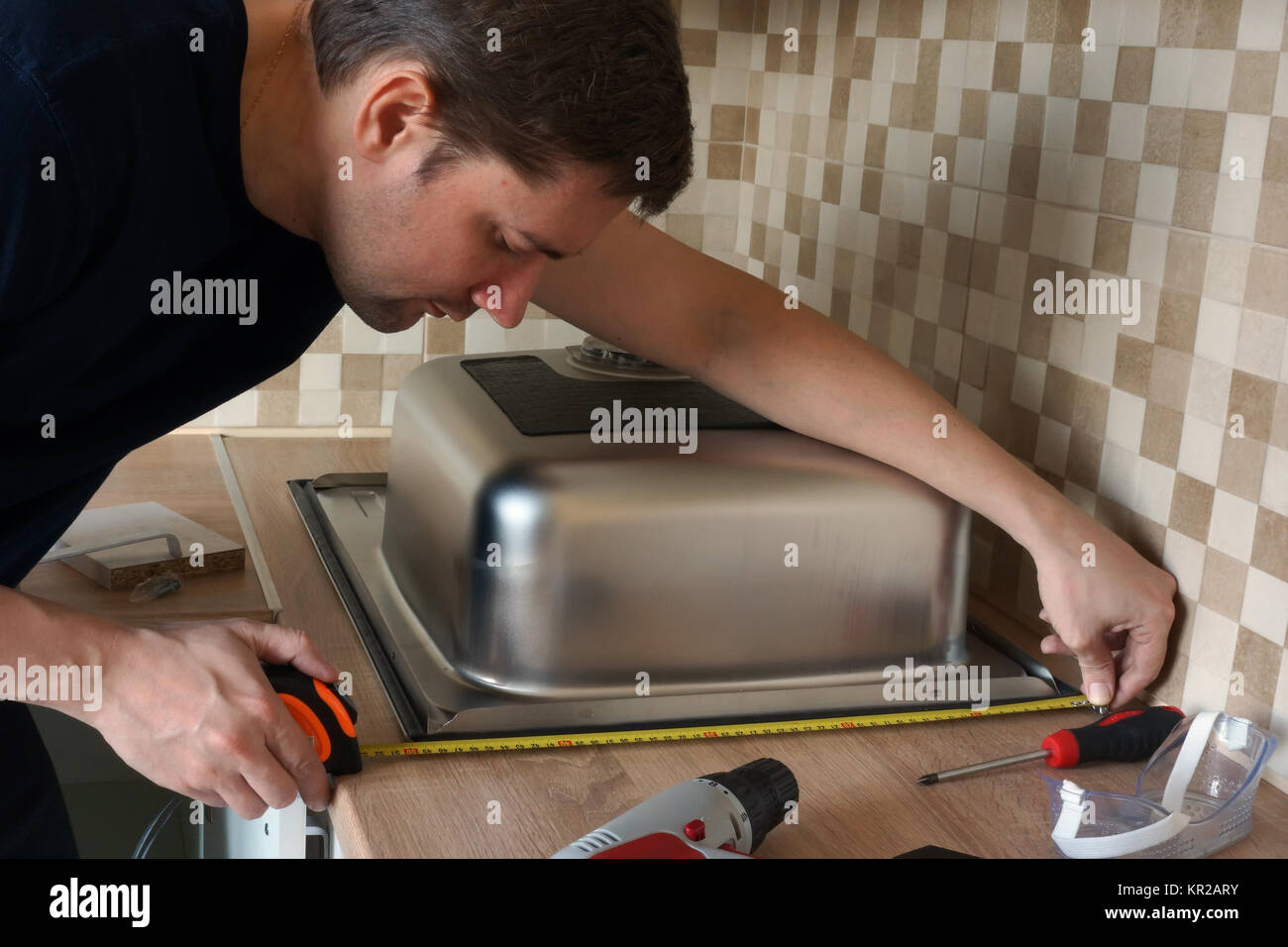 Stainless Steel Kitchen Sink Installation By A Man