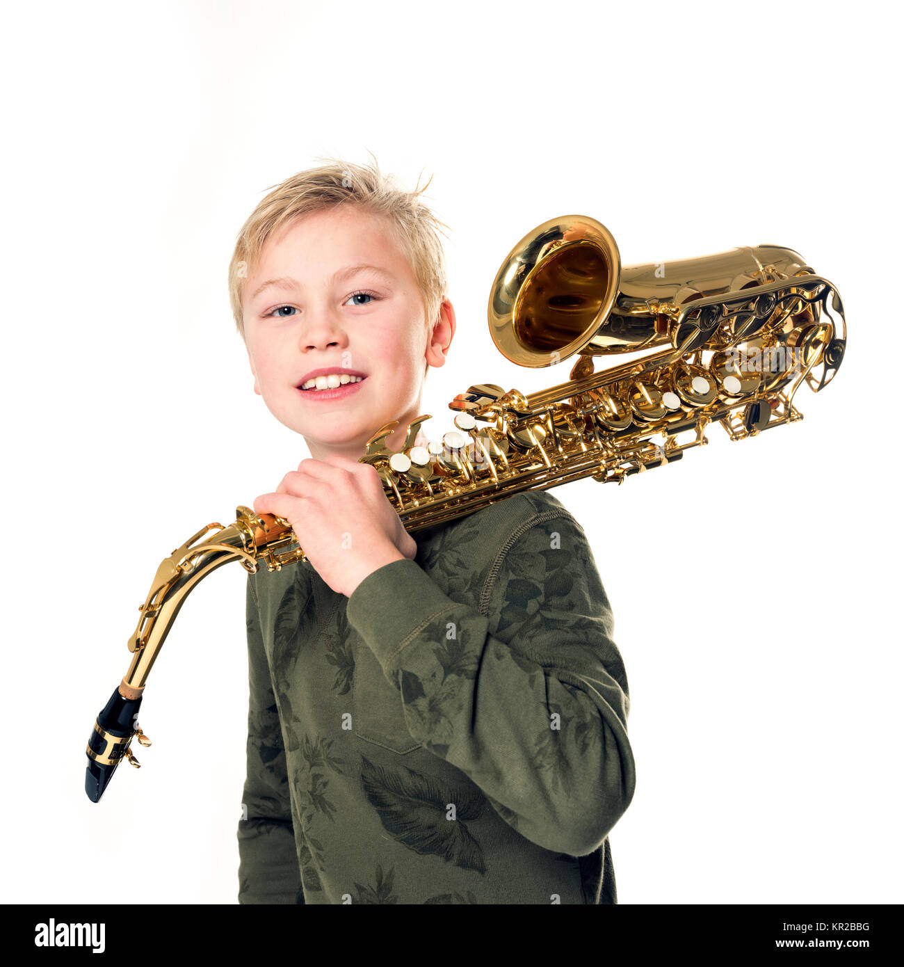 young blond boy and saxophone in studio against white background Stock Phot...