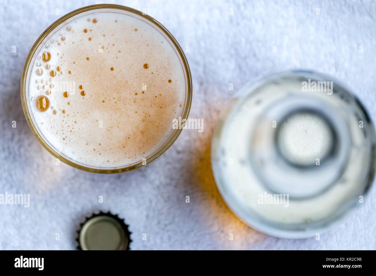 Top View of Beer Glass Next to Bottle and Bottle Cap Stock Photo - Alamy