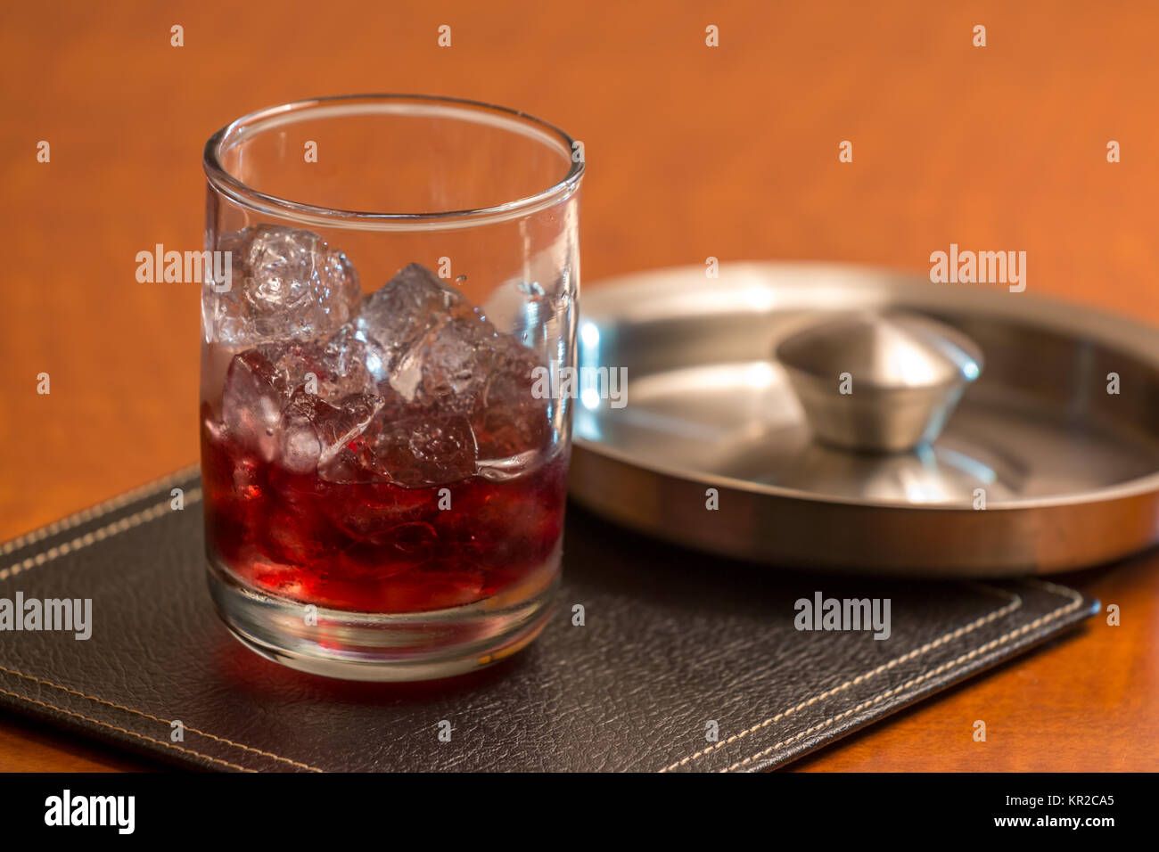 Red Liquor On Ice on Squre Leather Coaster with Metal Lid on the