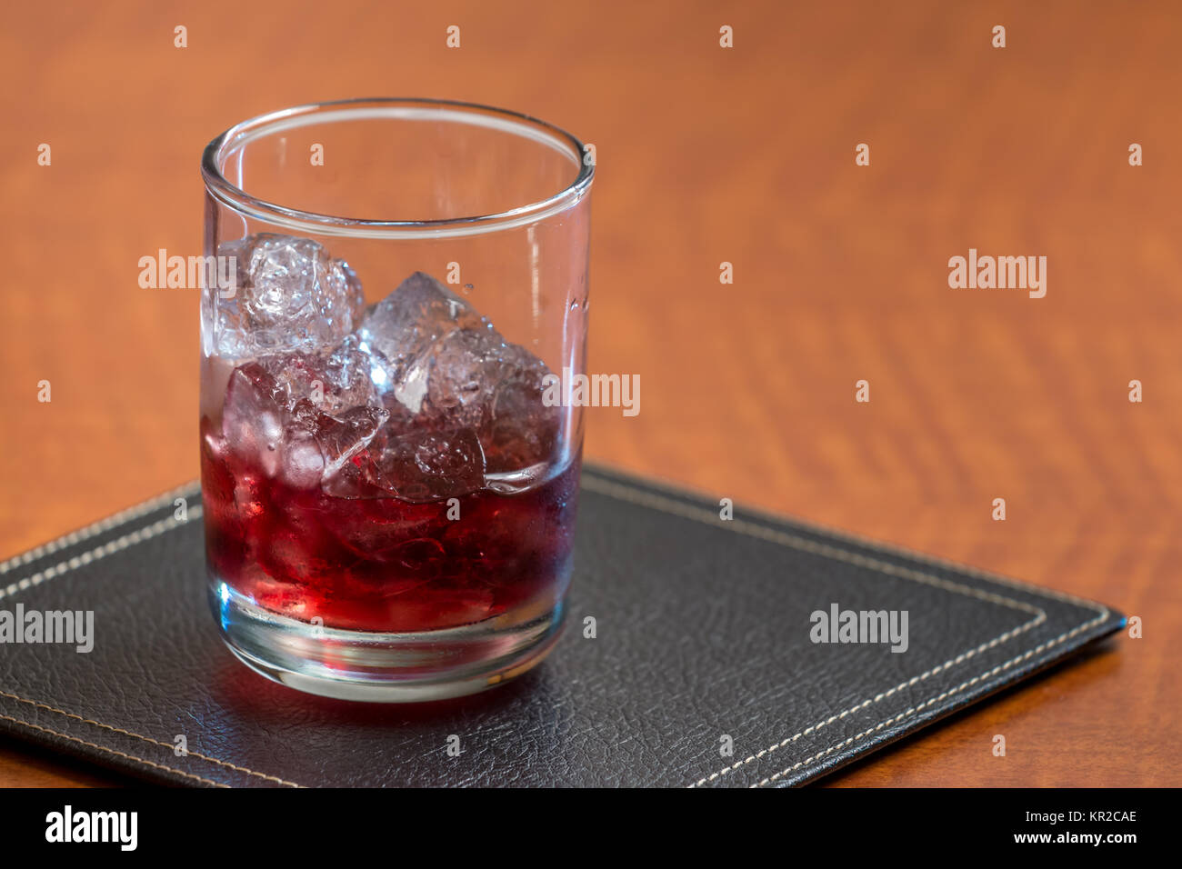 Red Liquor On Ice on Squre Leather Coaster Stock Photo Alamy