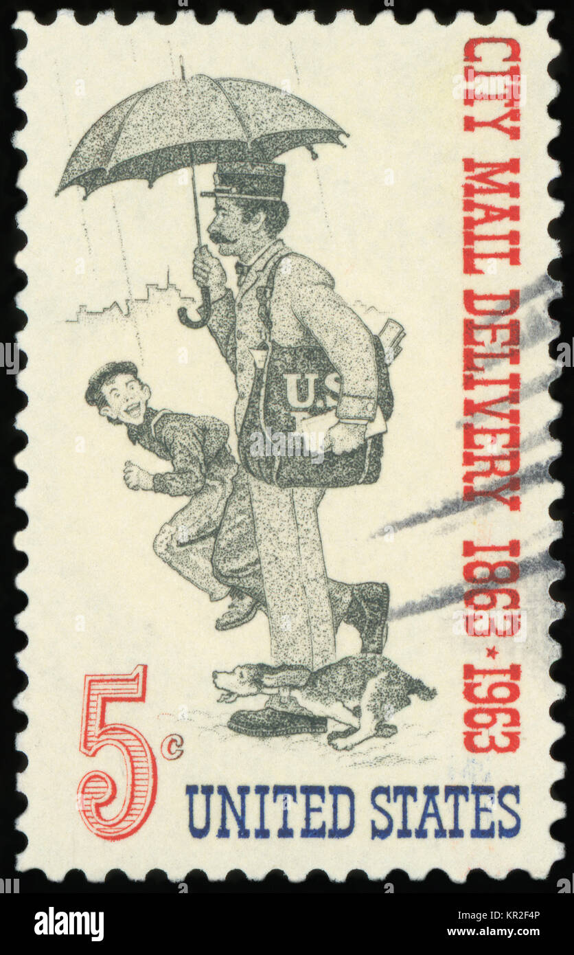UNITED STATES OF AMERICA - CIRCA 1963: A stamp printed in USA dedicated to the Free City Mail Delivery Centenary shows Letter Carrier, circa 1963 Stock Photo