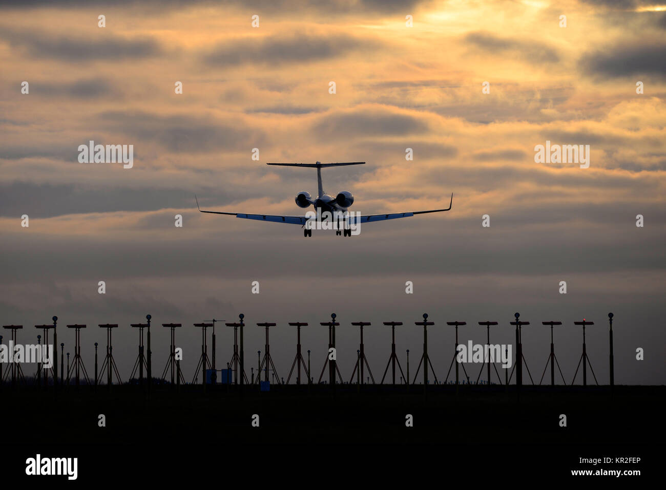 Gulfstream V GV jet plane landing at London Stansted Airport at dusk. Space for copy Stock Photo