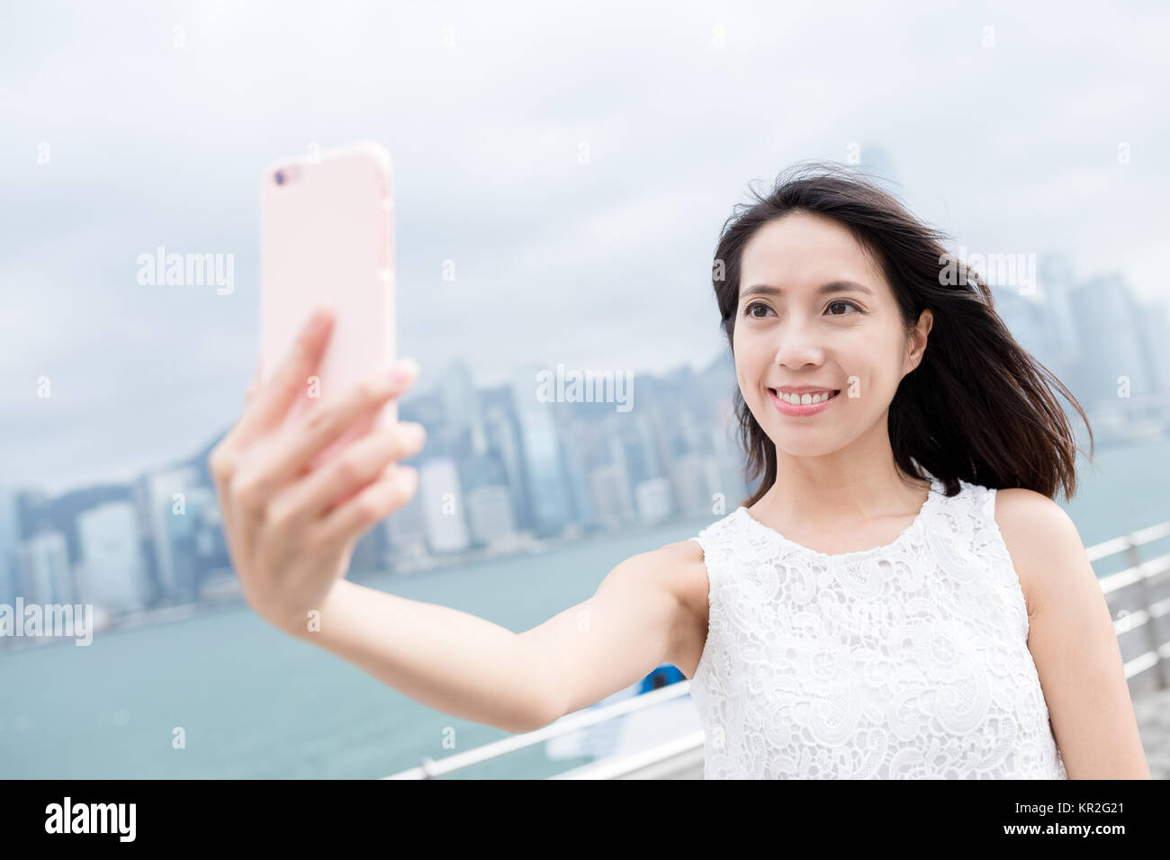 Woman take selfie at Hong Kong city Stock Photo - Alamy