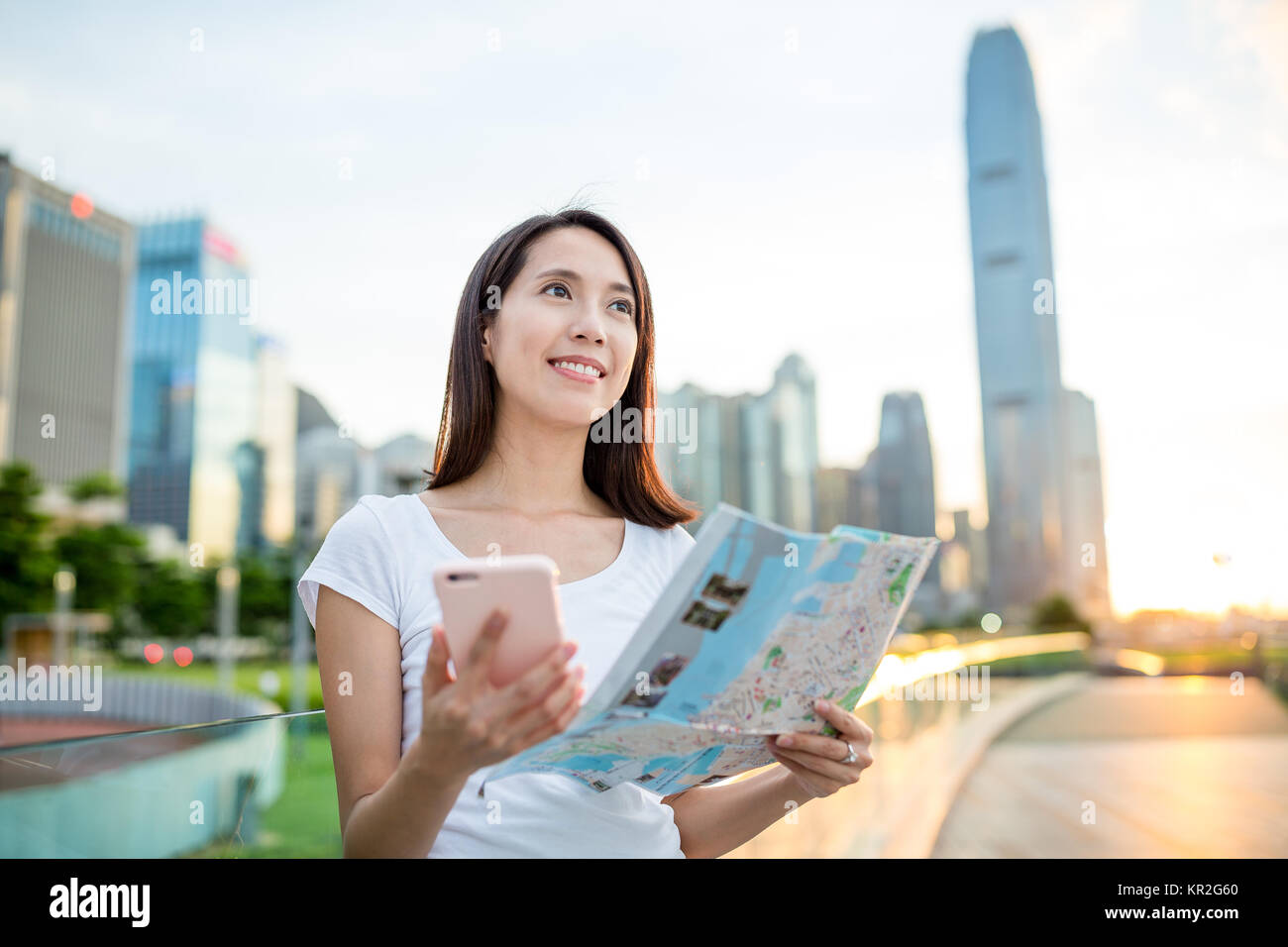 Woman using cellphone and city map in Hong Kong Stock Photo - Alamy