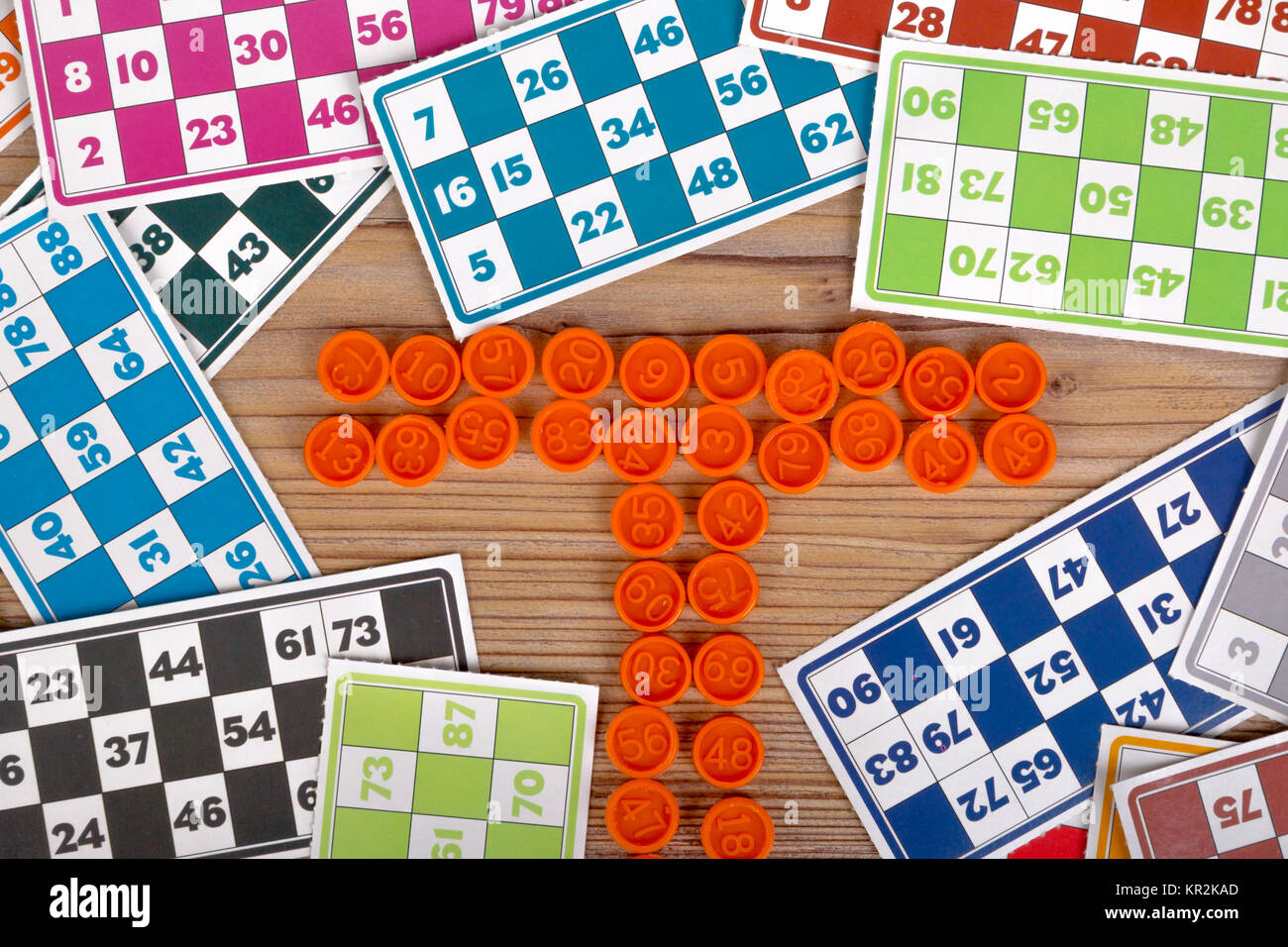 Colorful lotto or bingo game papers with numbers and plastic lotto barrels,  on wooden background Stock Photo - Alamy