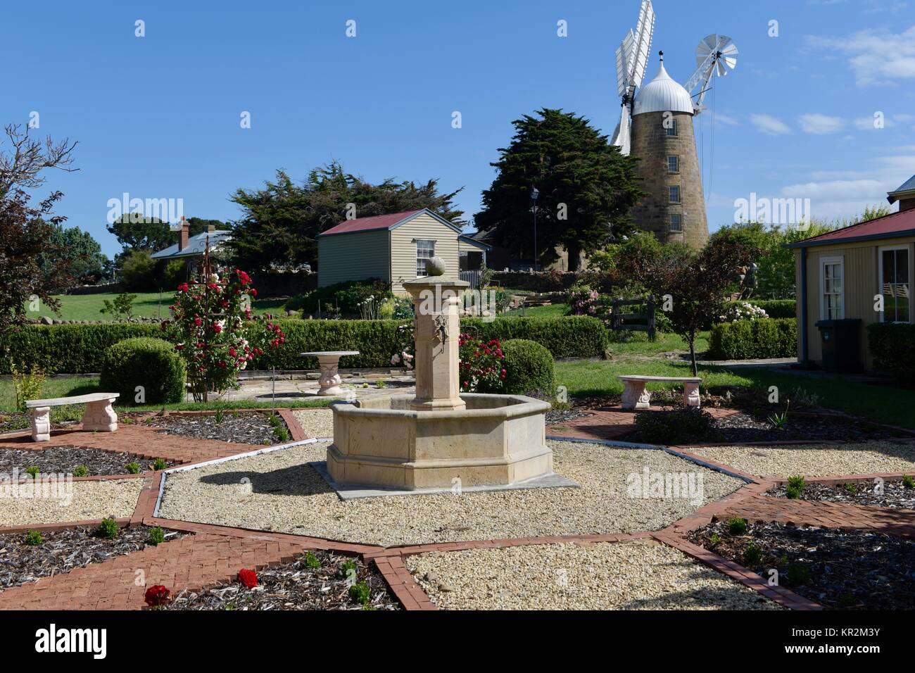 Traditional Australian homes with gardens in Tasmania, Australia. The beautiful restored Callington mill stands in the background. Stock Photo