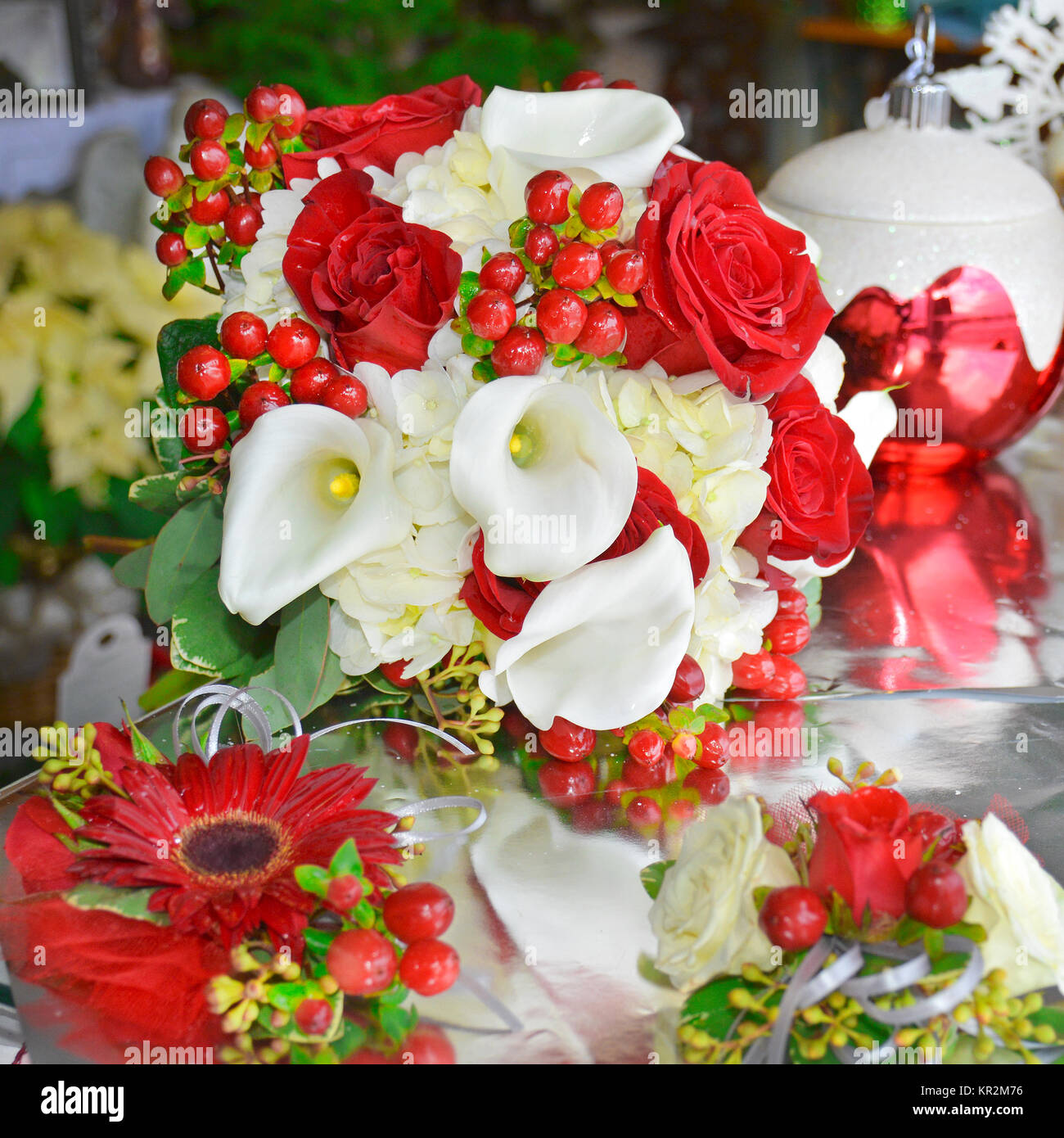 Photo of a holiday red and white bridal bouquet. Calla lilies, roses, hypericum berries, hydrangea and gerbera dasies are also available year-round. Stock Photo