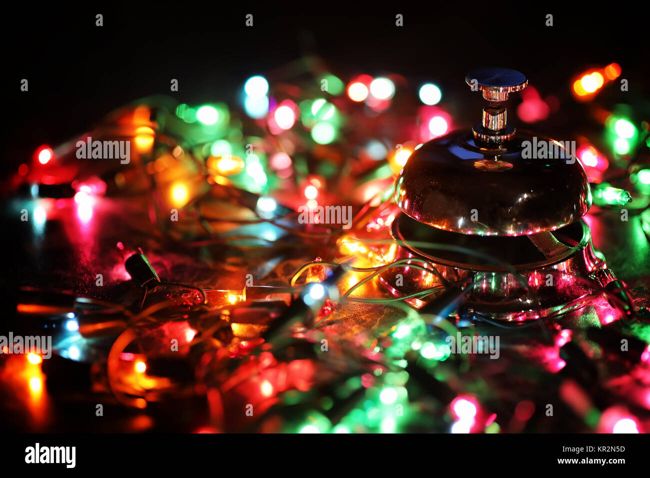 reception bell on table and color shining garland on background Stock ...