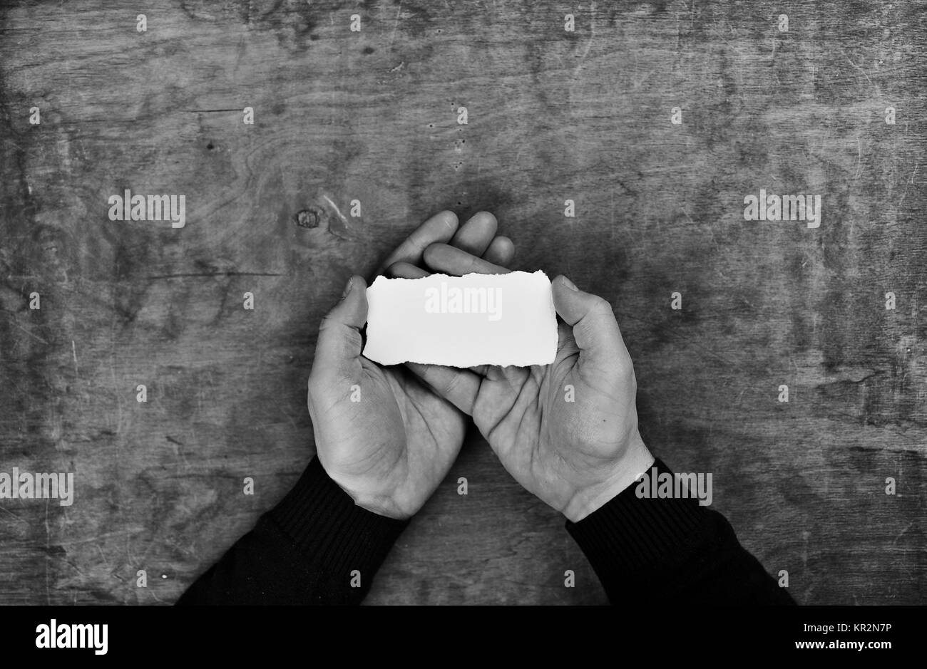 monochrome photo male hands holding a white blank sheet of paper Stock ...