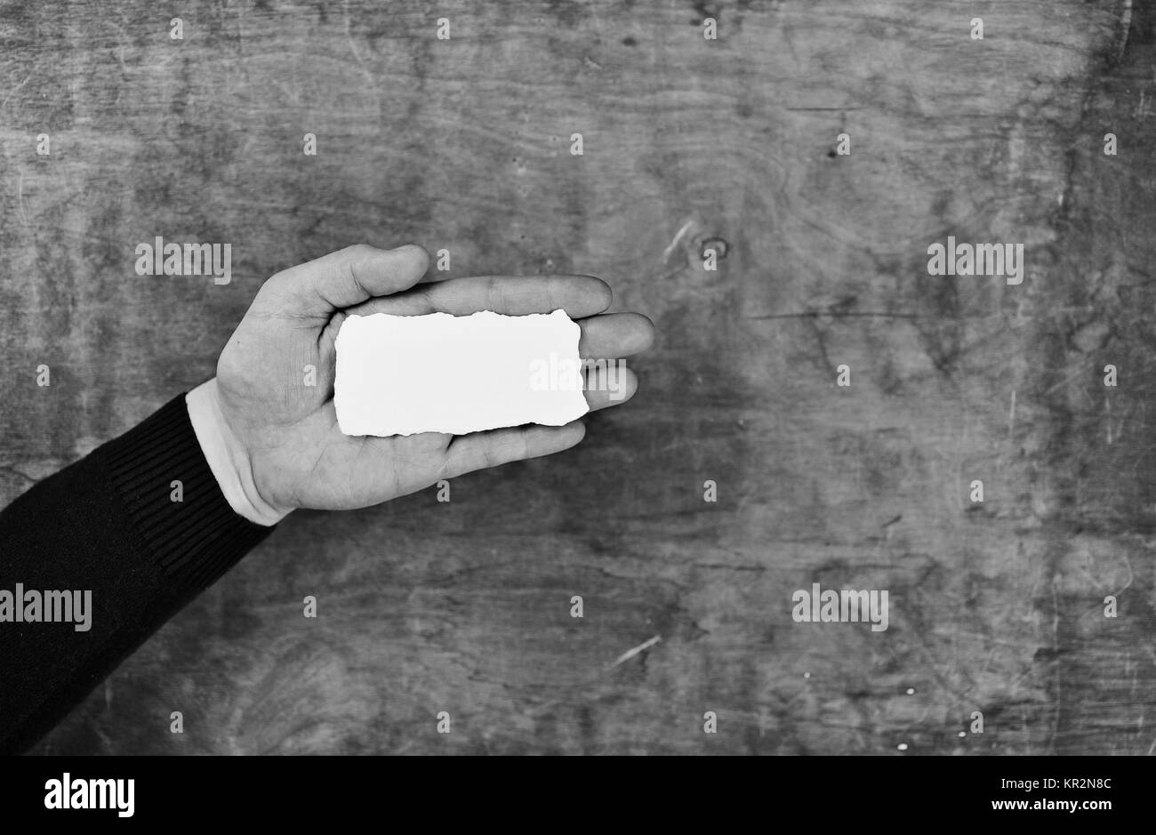 monochrome photo male hands holding a white blank sheet of paper Stock ...