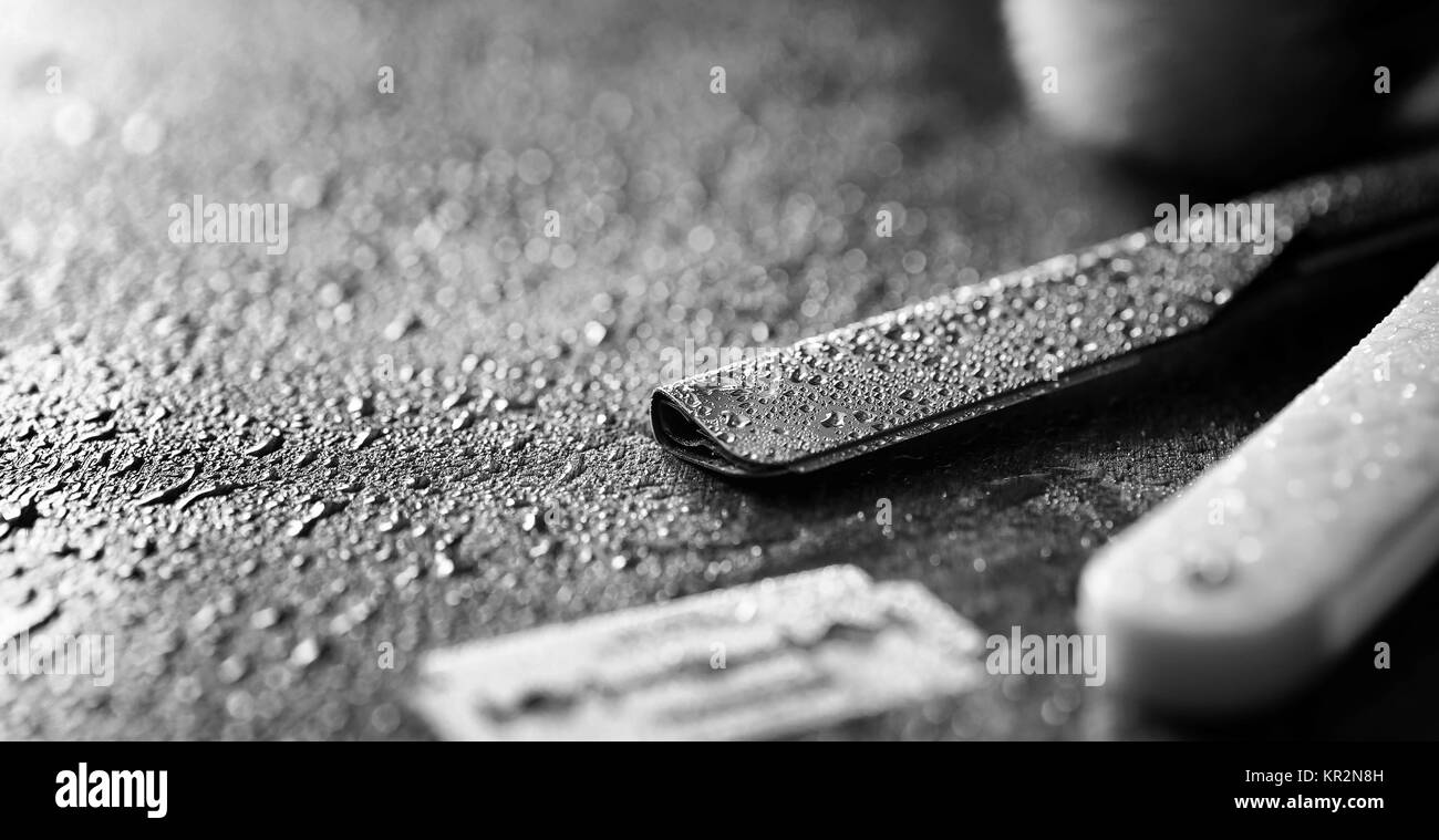 A dangerous razor and a metal blade on the table. Men's shaving Stock