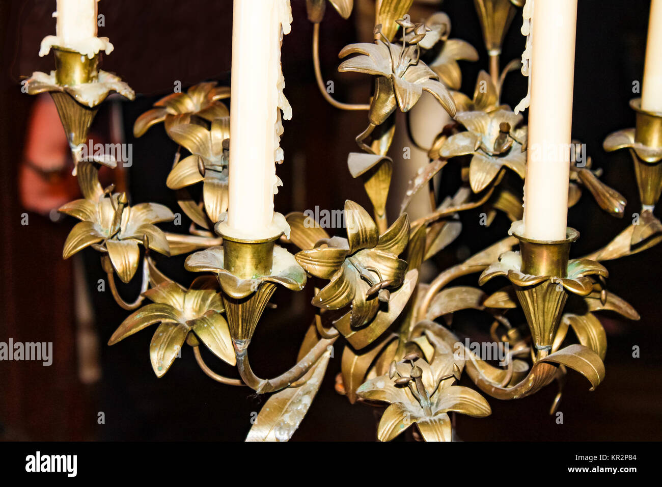 Closeup detail of old bronze chandelier with candles dripping wax Stock Photo