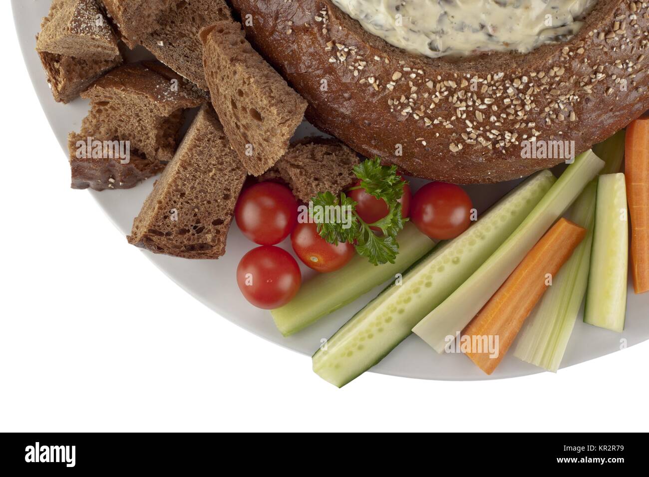 pumpernickel bread with spinach dip vegetables slices and bread cubes