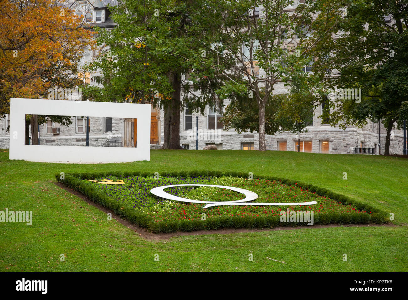 The Queen's University logo and a garden at Queen's University at Kingston in Kingston, Ontario, Canada. Stock Photo